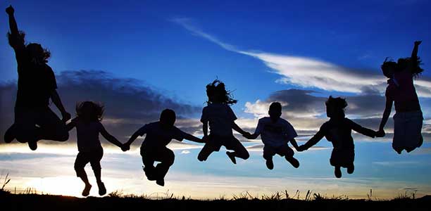 silhouette image of people jumping